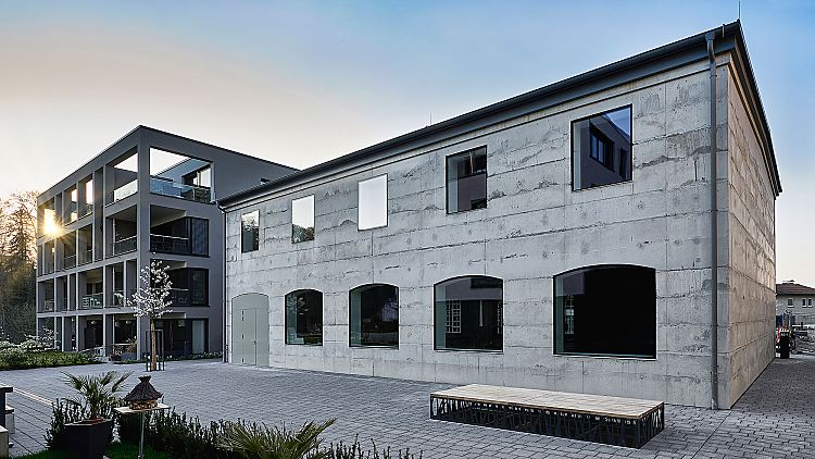 Die rückseitige Sichtbetonfassade zitiert die historische Front und lässt ebenso viel Licht ins Innere